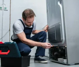 adult-bearded-repairman-in-working-overall-fixing-refrigerator-by-screwdriver-in-kitchen-1024x684.jpg